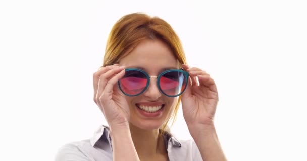 Beautiful happy fun young redhead hair cool adult woman smiling and using sunglasses.Person action.People video portrait isolated on white background.Medium shot.4k video — Stock Video