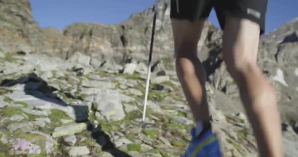 男の足は崖の端を走る。トレイルランナーは、岩の登りで山頂のピークトレーニングに走ります。日の出や日没のバックライトで屋外の野生の緑の自然。活動、スポーツ、努力、挑戦、意志の概念 — ストック動画