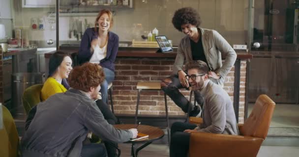 Collega's en klanten praten strategie met laptop en tablet. Groep van multi-etnische mensen die informele zakelijke teamvergadering in restaurant lounge. Teamwork, corporate, diversiteit en sociale concepten — Stockvideo