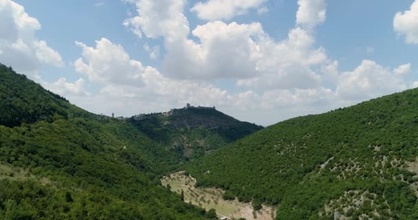 Вид с воздуха над сельской местностью или деревней или городом Ассизского замка. Приближаюсь к основателю. Итальянская поездка в беспилотнике Umbria.4k — стоковое видео