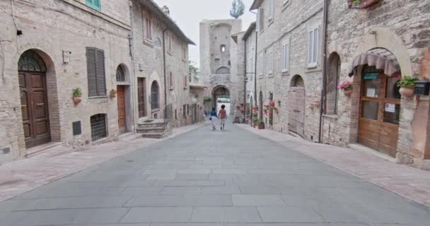 Pareja romántica caminando visitando la ciudad rural de Assisi.Back follow.Friends viaje italiano en Umbria.4k cámara lenta — Vídeo de stock