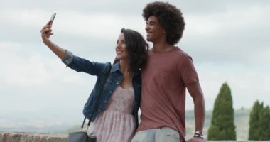 Romantik Çift bir selfie smartphone ile kırsal kasaba Assisi.Portrait ortamda alarak vurdu. Arkadaşlar Umbria.4k yavaş çekimde İtalyan yolculuk