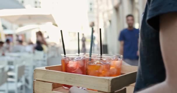 Waiter brings cocktails to four people or two couples at aperitif in city cafe.Medium portrait shot Friends italian trip in Umbria.4k slow motion — Stock Video