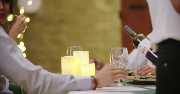 Ober het gieten van rode wijn in vrouw glas terwijl mensen, praten, eten, drinken tijdens Romantisch Gastronomisch verzamelen diner of lunch. Glanzende verlichting. Medium schot. Vrienden Italiaanse reis in Umbrië. 4k Slow Motion — Stockvideo