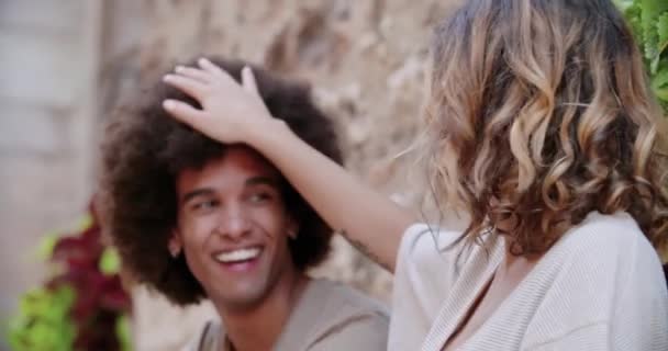 Mujer tocando mans pelo sonriente. Mujer acaricia mans cabeza en el casco antiguo. Luz cálida retroiluminada. — Vídeos de Stock