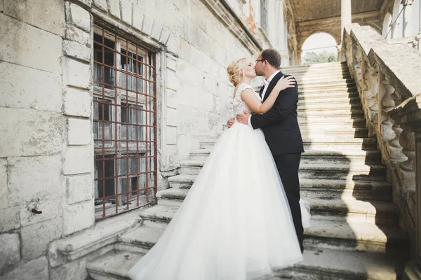 Güzel, romantik bir düğün. Yeni evliler. Eski kalenin yakınlarında sarılıyorlar. — Stok fotoğraf