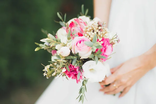 新娘手里拿着花束，又大又漂亮的婚纱 — 图库照片