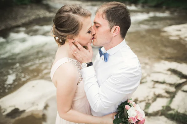Bride smiles with closed eyes while groom touches her face delicately — Stock Photo, Image