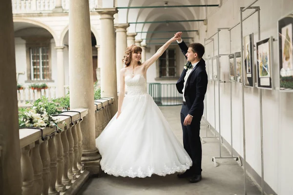 Preciosa pareja feliz boda, novia con vestido blanco largo posando en la hermosa ciudad —  Fotos de Stock