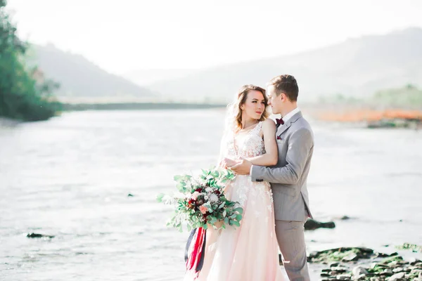 Boda pareja, novio y novia abrazos, al aire libre cerca del río —  Fotos de Stock