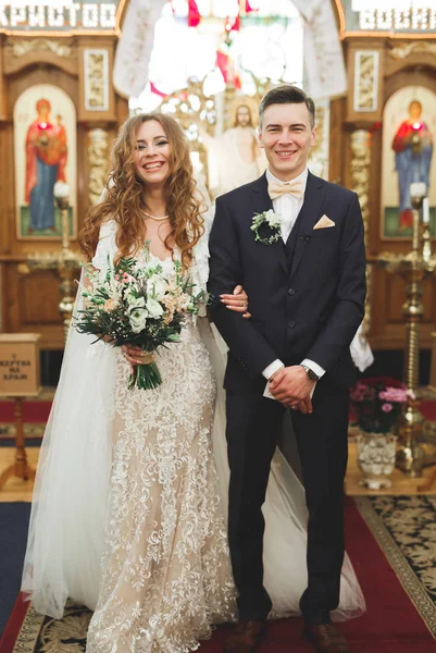 Married couple posing in a church after ceremony — Stock Photo, Image