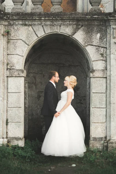 Belo conto de fadas casal recém-casado abraçando perto do velho castelo medieval — Fotografia de Stock