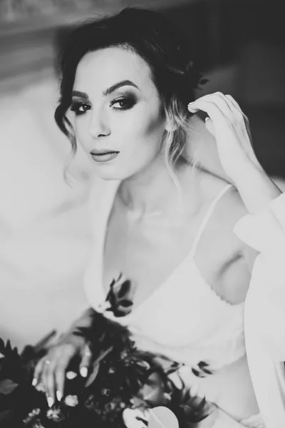 Gorgeous bride in robe posing and preparing for the wedding ceremony face in a room — Stock Photo, Image