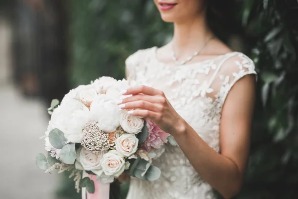 Bride holding big and beautiful wedding bouquet with flowers — Stock Photo, Image