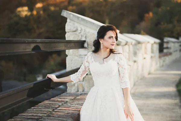 Beautiful bride posing in wedding dress outdoors — Stock Photo, Image