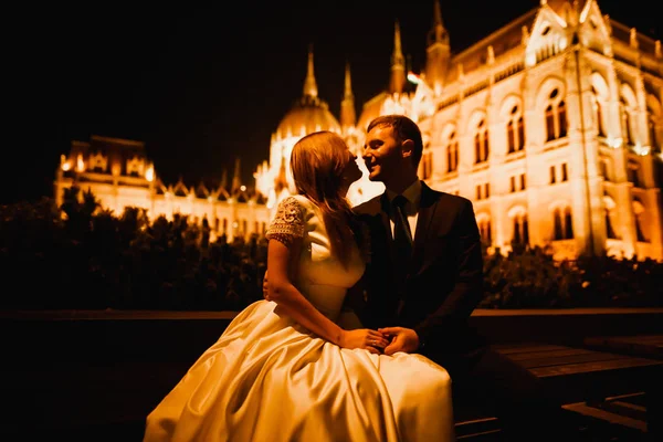 Bela noiva e noivo abraçando e beijando em seu dia de casamento ao ar livre — Fotografia de Stock