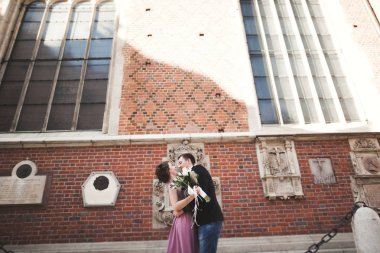 Muhteşem Düğün çifti, damat ve gelin pembe elbise Krakow eski şehirde yürüyüş ile