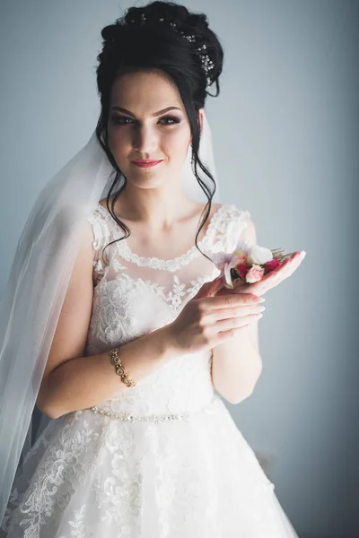 Linda noiva em roupão posando e se preparando para o rosto cerimônia de casamento em uma sala — Fotografia de Stock