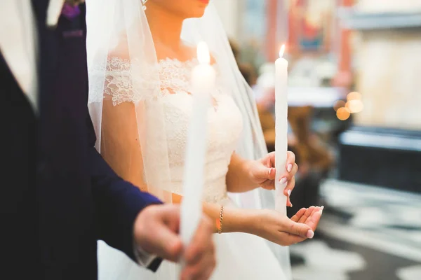 Házaspár pózol egy templomban szertartás után — Stock Fotó