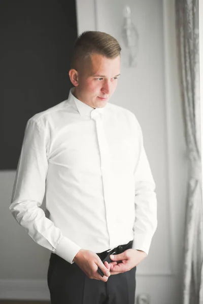 Grooms morning preparation. Handsome man getting dressed and preparing for the wedding — Stock Photo, Image