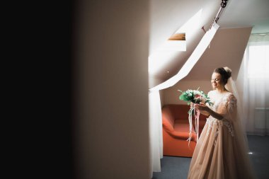 Tüylü, lüks makyaj, saç stili, stüdyo içi fotoğraf çekimi olan güzel bir gelin.