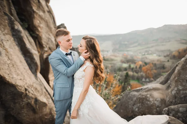 Beautiful gorgeous bride posing to groom and having fun near at mountains with amazing view, space for text, wedding couple — Stock Photo, Image