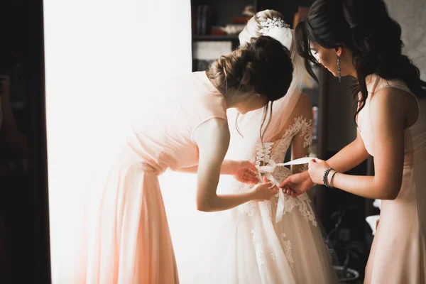 Hands of bridesmaids on bridal dress. Happy marriage and bride at wedding day concept — Stock Photo, Image