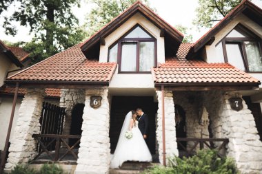 Güzel mutlu bir düğün çifti, uzun beyaz elbiseli gelin.