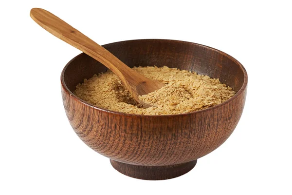 Ahşap kase beyaz arka plan üzerinde izole beslenme bira Maya flakes