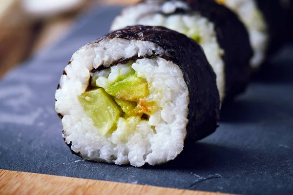 Vegan sushi rolls made with nori algae, sushi rice, cucumbers and avocado