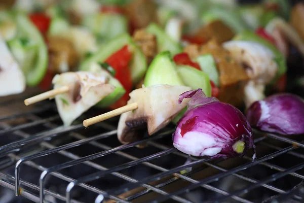 Vegetable skewers on grill with seitan, mushrooms, zucchini, tomato and bell peppers