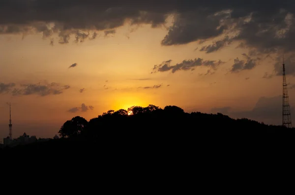 Sole arancio tramonto tra la foresta e le montagne — Foto Stock