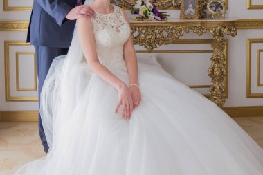 damat gelini parlak bir odada yanında duruyor