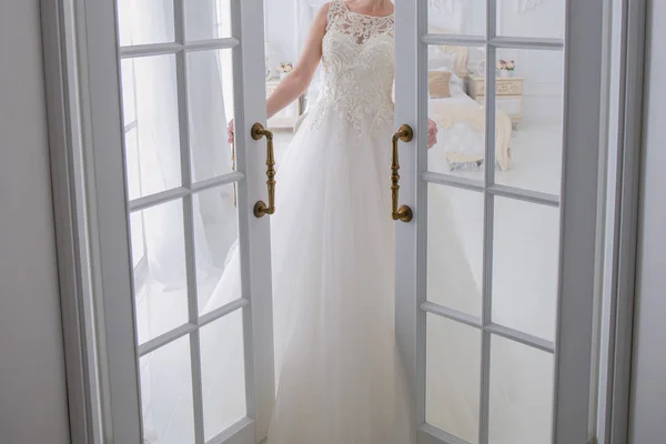 ウェディング ドレスの花嫁がドアの横に立っています。 — ストック写真