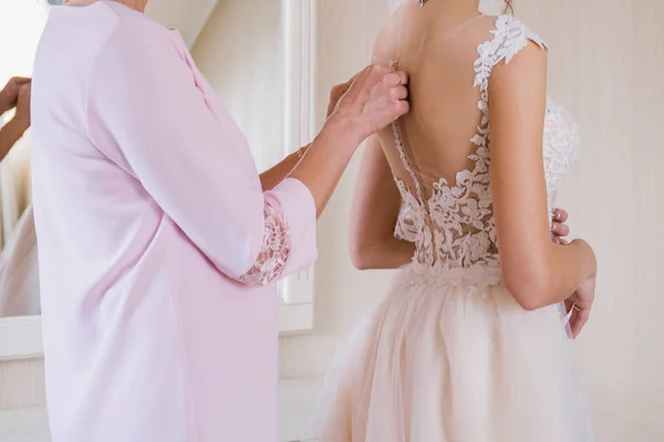 Bride put on a wedding dress in the room — Stock Photo, Image