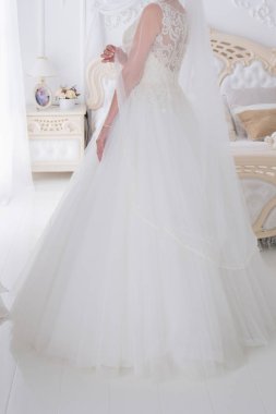 gelin düğün buket aydınlık bir salonda tutar.