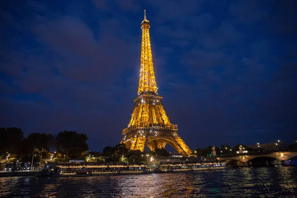 A Torre Eiffel em Paris brilha com luzes à noite — Fotografia de Stock