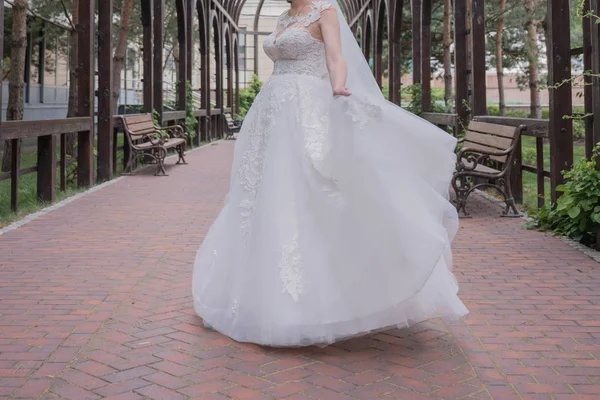Bruid in trouwjurk wervelingen in het park — Stockfoto
