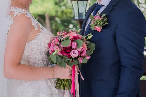 Noiva e noivo ficar juntos sob o arco da cerimônia de casamento — Fotografia de Stock