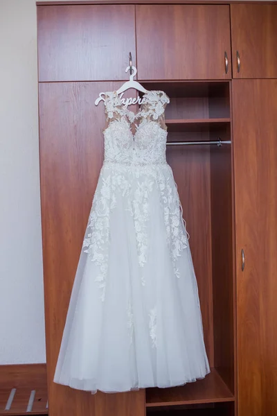 bridesmaid dress hanging on the closet in the room