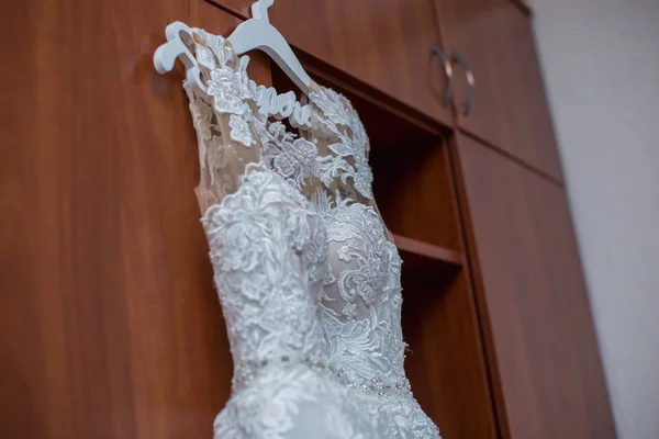 bridesmaid dress hanging on the closet in the room