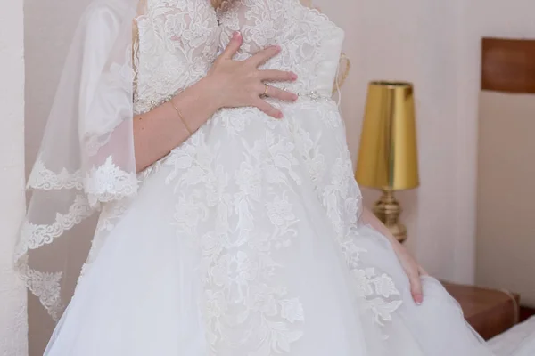 Bride in dressing gown and wedding dress in hands — Stock Photo, Image