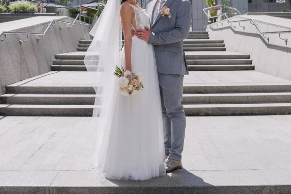 Bride and groom on the big staircase — Stock Photo, Image