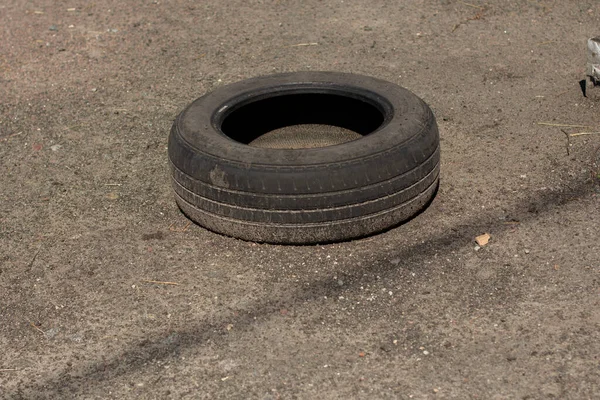 a old car tire on asphalt