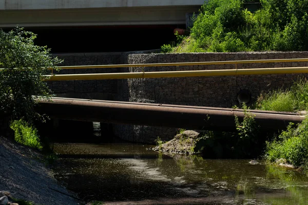 a large pipes over the river