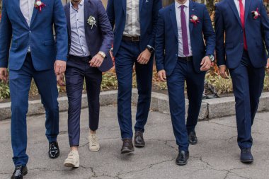 Düğünde damat parkta takım elbise giymiş.