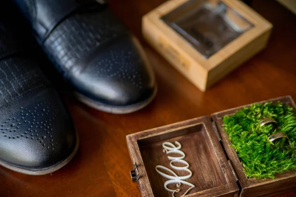 a box for wedding rings and groom's shoes