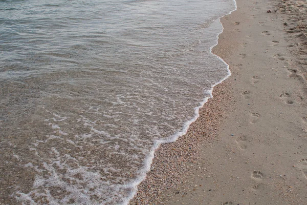 a sandy seashore with clear sea water