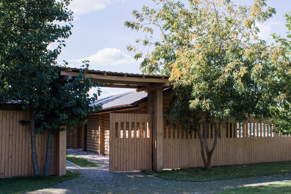a green meadow with a wooden fence