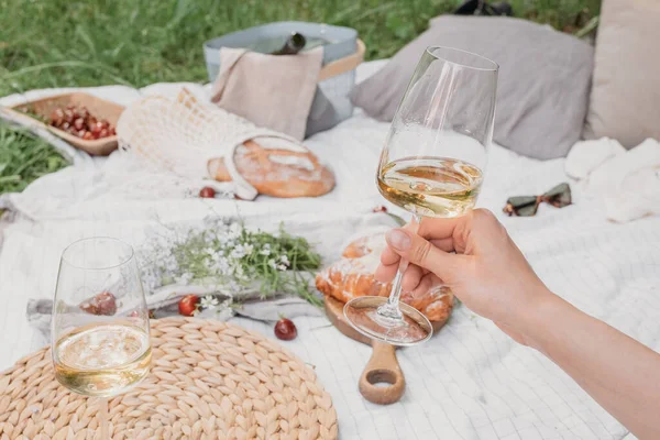 Aesthetic picnic outdoors with wine glasses bread berries and flowers.  Rustic picnic with neutral tones colours. Stock Photo by  ©lamapacas.gmail.com 378420028